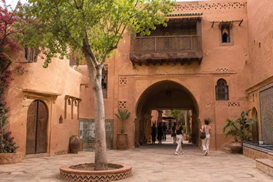 Ochre arches, mosaic details and courtyard inside Medina Polizzi Agadir