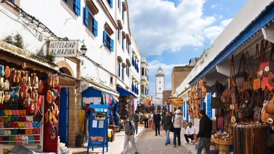 Market street with white walls and blue details in Essaouira Medina
