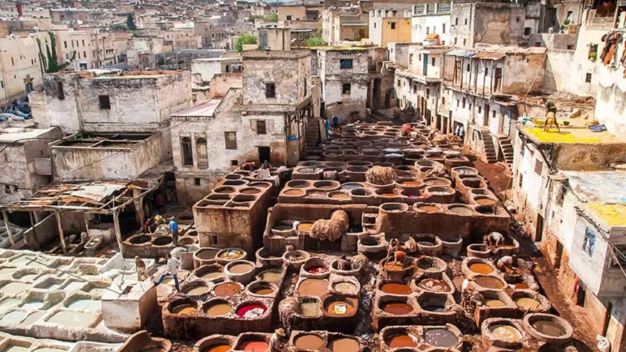 Colorful leather dye vats and workers at Chouara Tannery in Fes