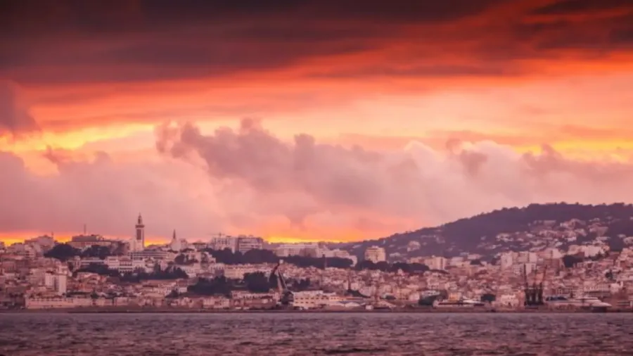 Orange sunset over Tangier's coastal skyline and Strait of Gibraltar