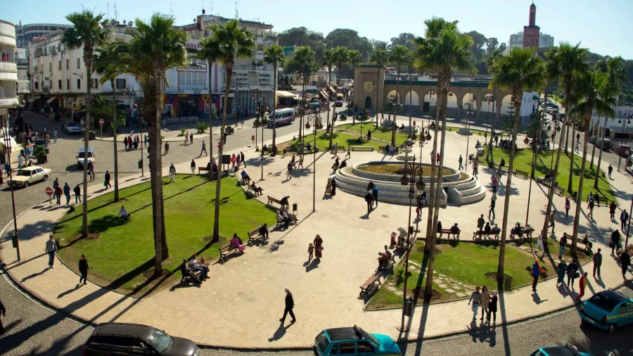 Palm trees, fountain and city life around Grand Socco in Tangier